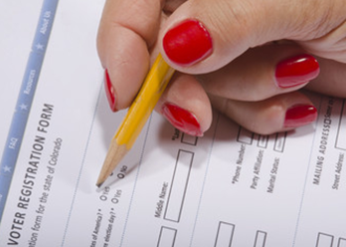 Person filling out a voter registration form